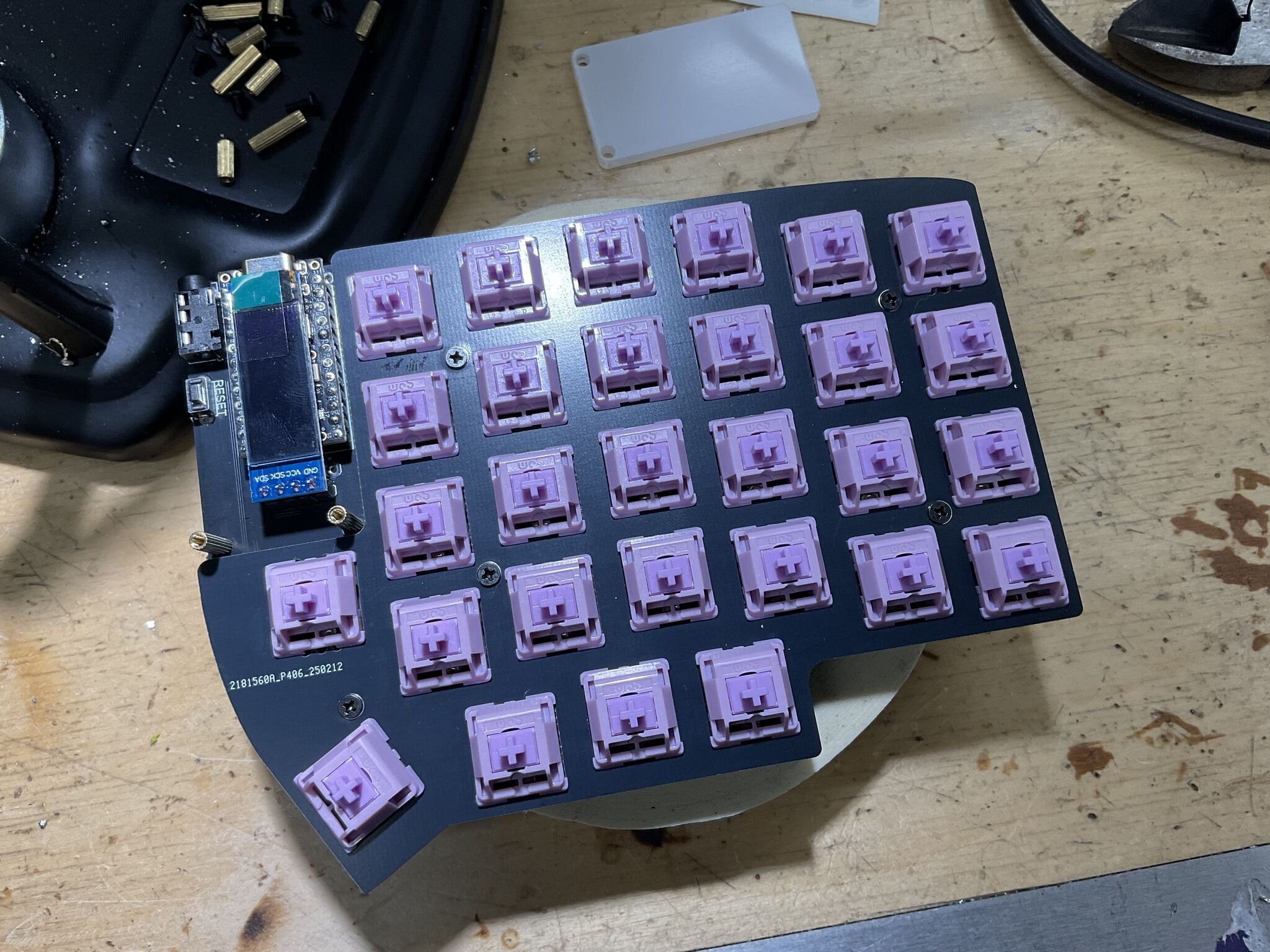 Switches snapped into the hot-swap sockets on the right half, with the Pro Micro and OLED mounted. The keyboard is starting to look like a keyboard.